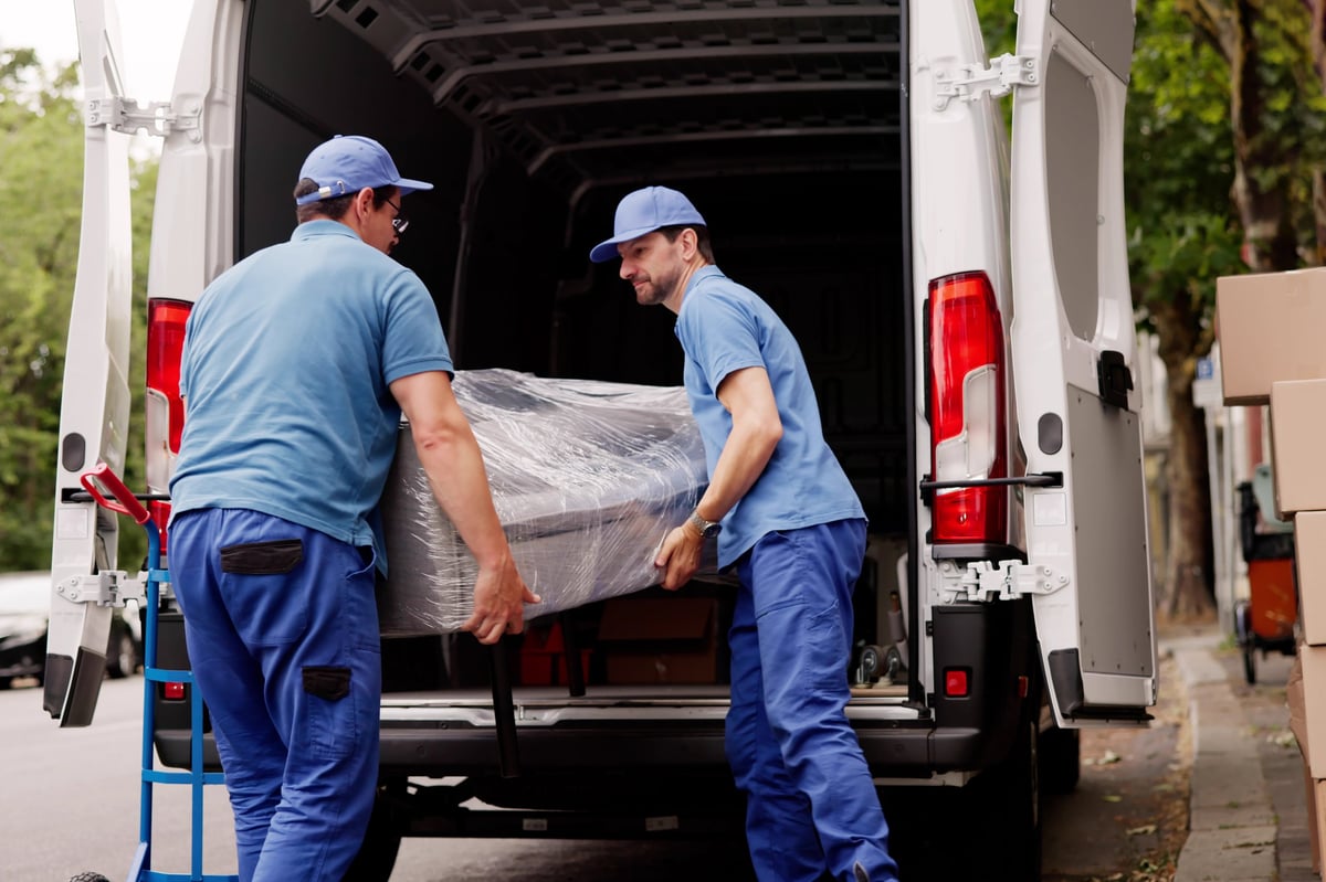 Professional Movers Outside Assisting With Furniture Removal From Client's House.